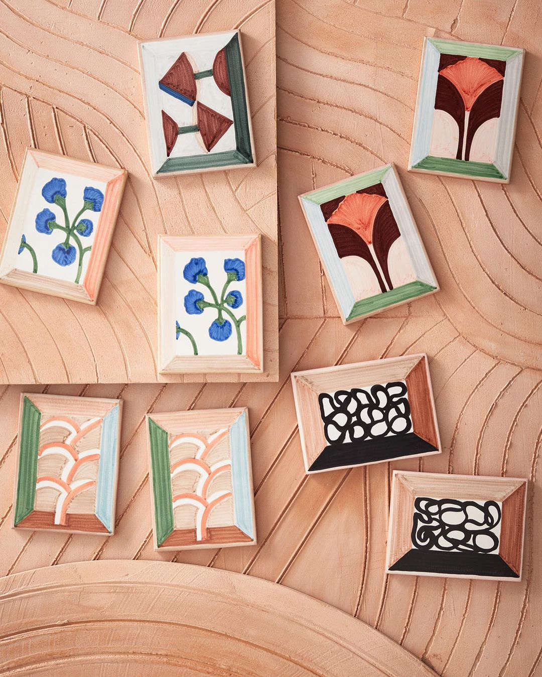 Frames incorporated into the designs make the tiles look like canvases. 