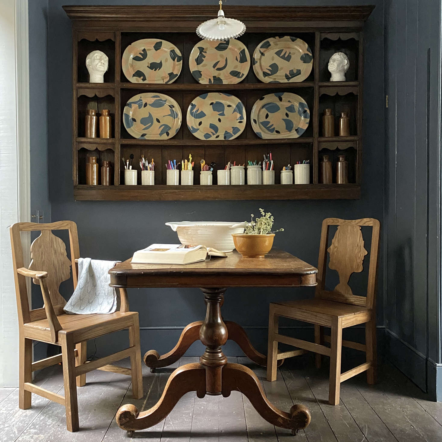 An antique table had to be adapted in width to fit the compact dining area. The chairs are Berdoulat