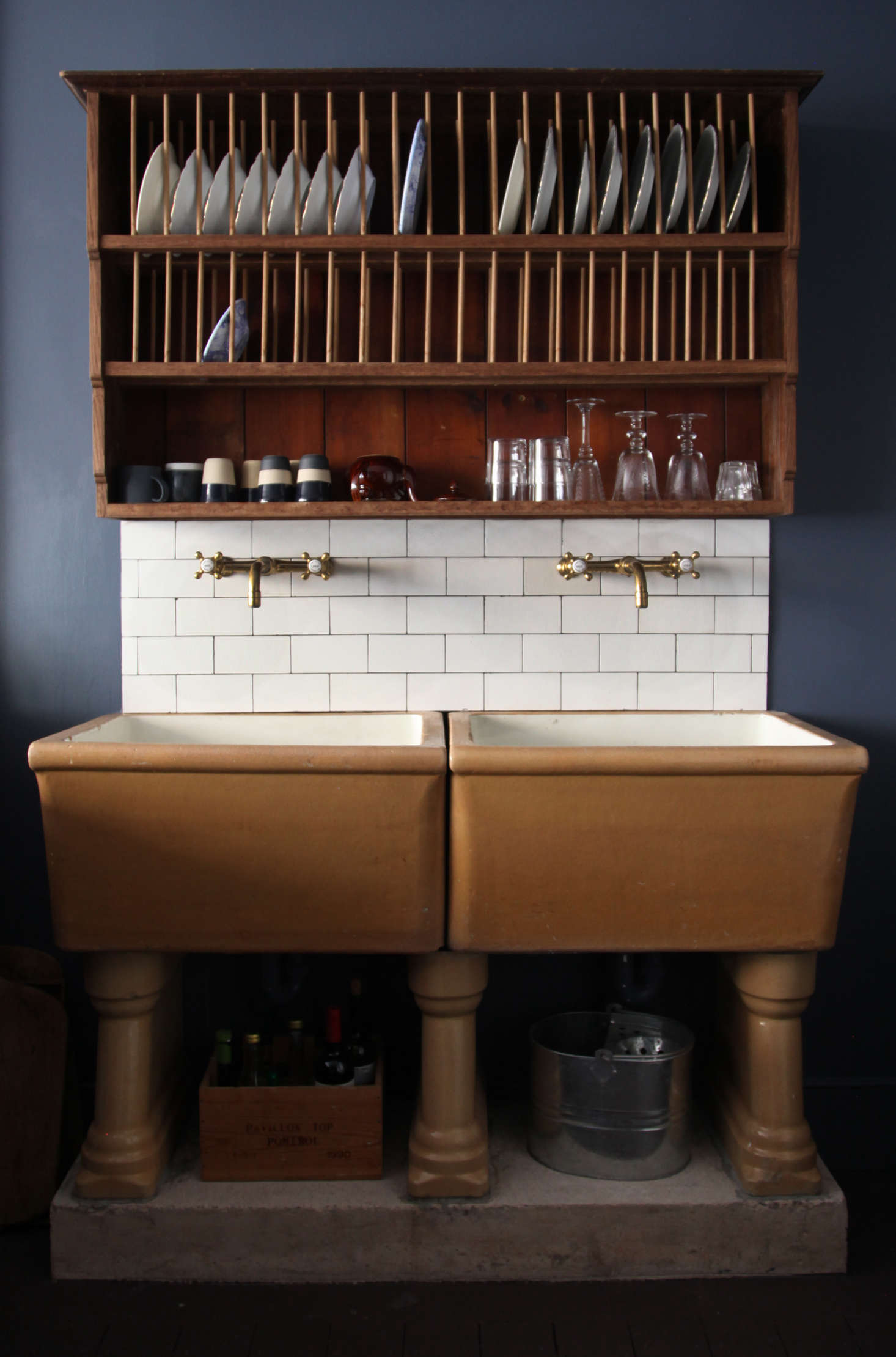The sink has Barber Wilsons brass faucets—Berdoulat is launching a range of taps with the company in a few months—and a backsplash of reclaimed subway tiles bought on eBay. The plate-drying rack is a prototype for one that will be sold in the Berdoulat shop along with other 
