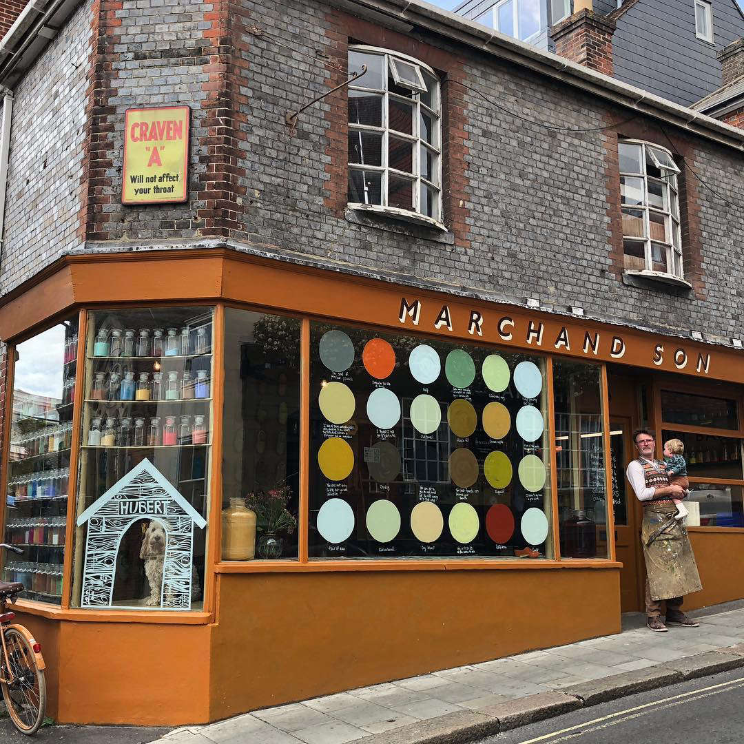 Simon March in front of his Lewes, East Sussex, shop with his young son.