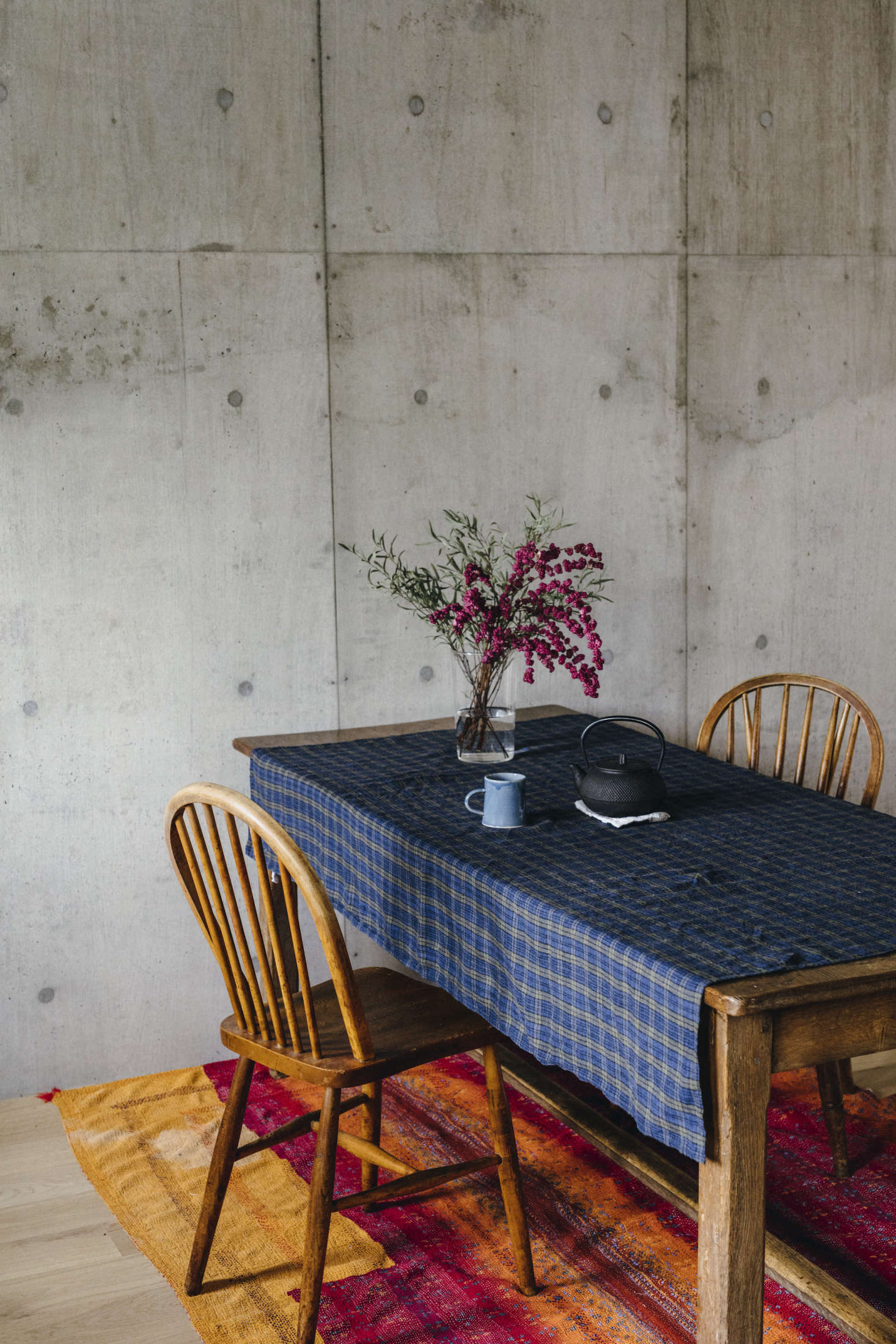 An early trip to Lithuania inspired Yumiko to produce linen for the home; shown here, a table draped in a check patterned cloth of her design in her Tokyo house.