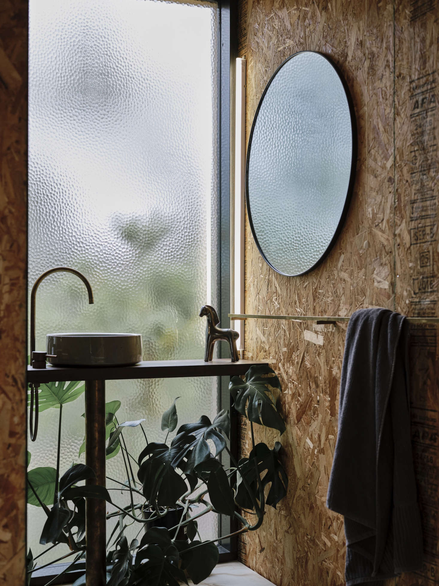 Textured glass allows privacy in the bathroom. The bathroom sink is by local ceramicist Lindsey Wherrett.