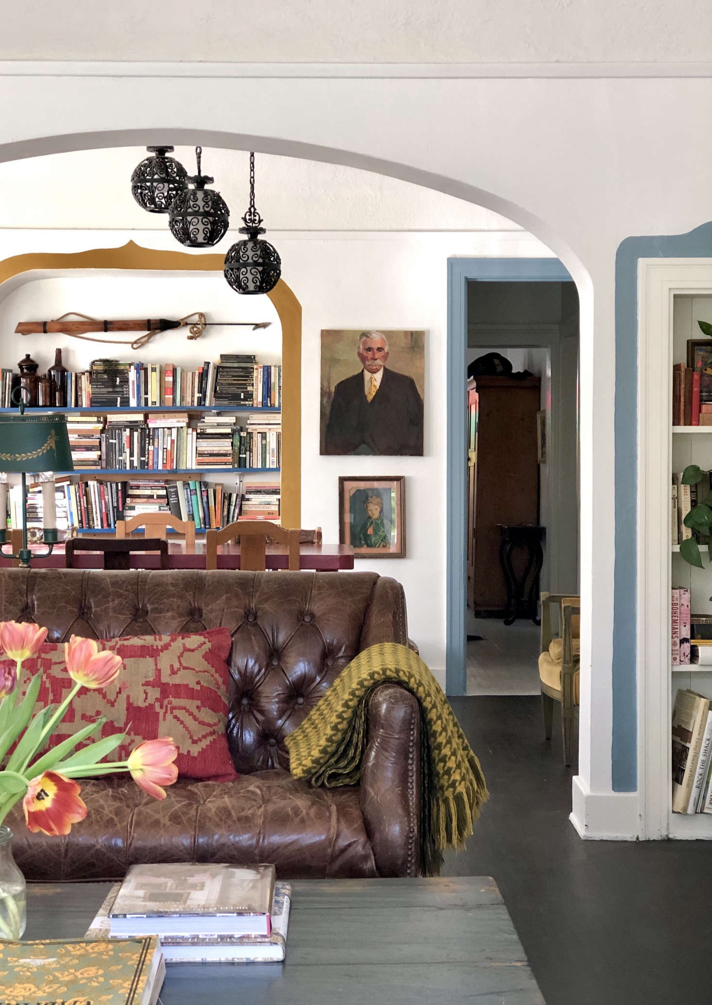 The doorway trim in the dining area echoes the book-case frame in the living room; both are painted in Behr
