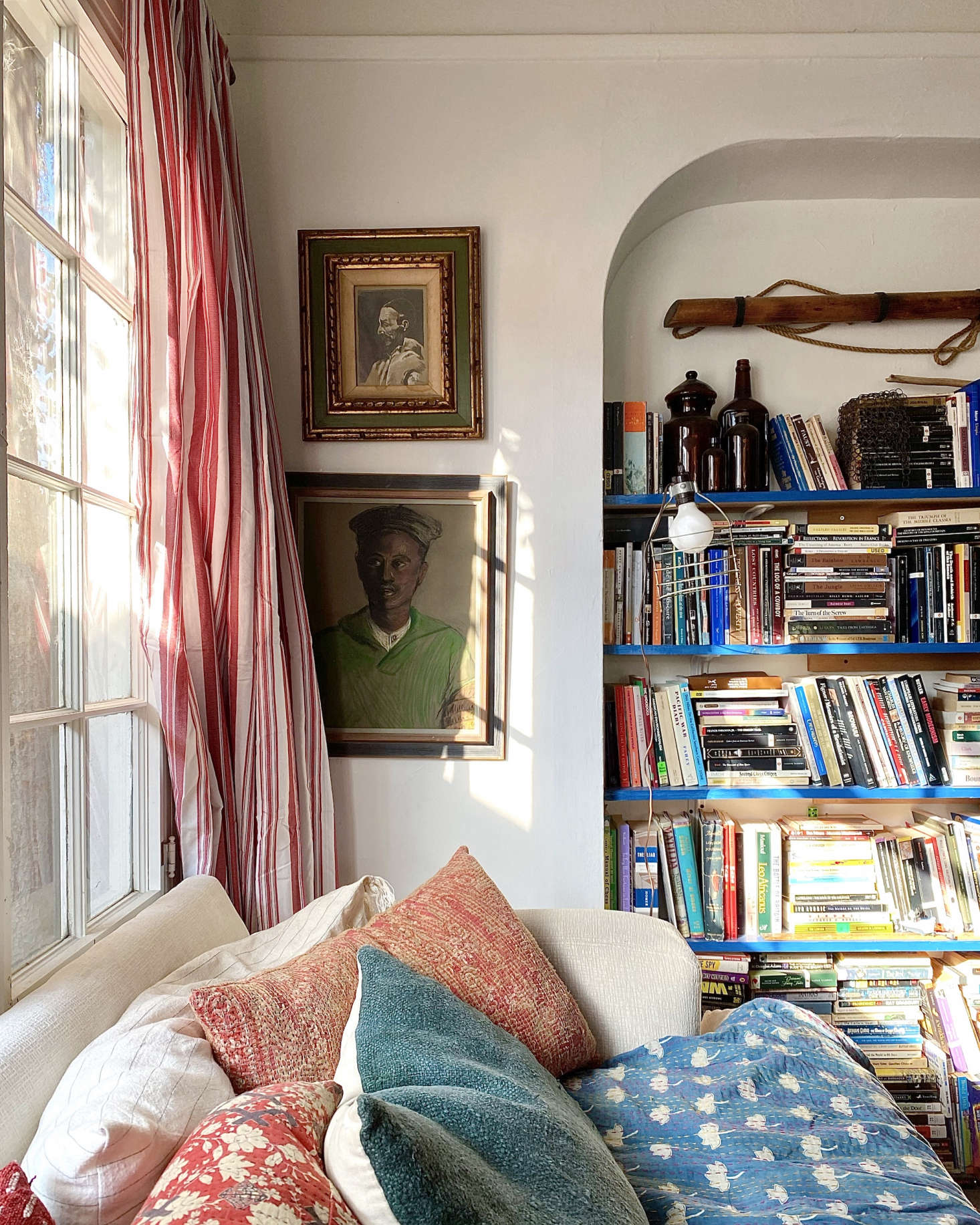A vintage quilt covers an old sofa that Gillian scored on Facebook Marketplace for just $0. 