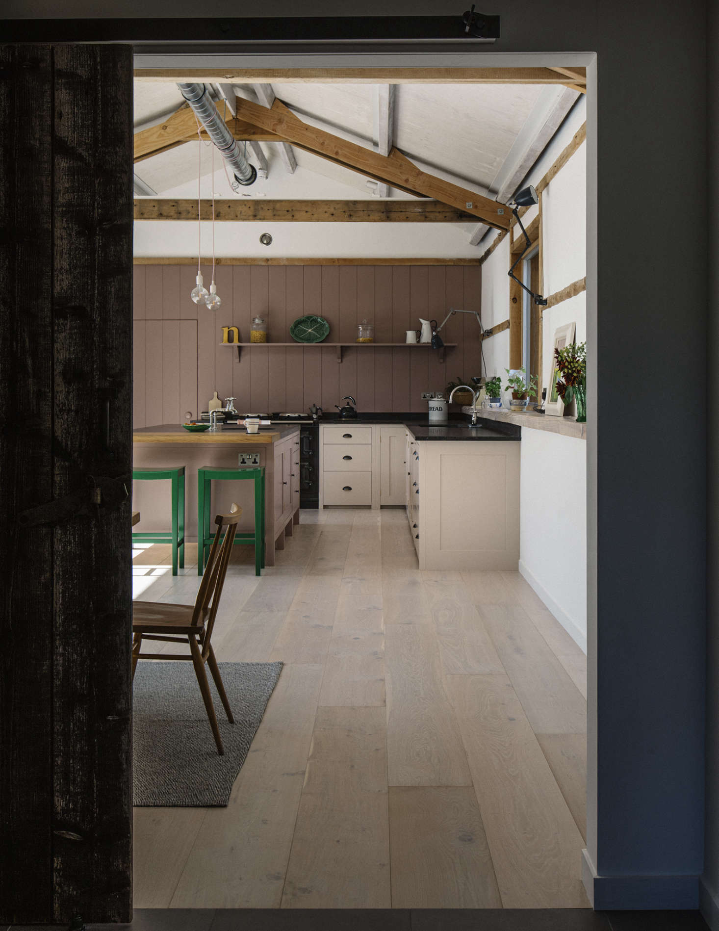 An adjoining vestibule links the kitchen to the 300-year-old main barn that houses the sitting room and bedrooms. The limed-oak wide floorboards—sourced affordably from a local warehouse store after first-choice Dinesen proved too pricy—have under-floor heating. The white walls are lime plaster.