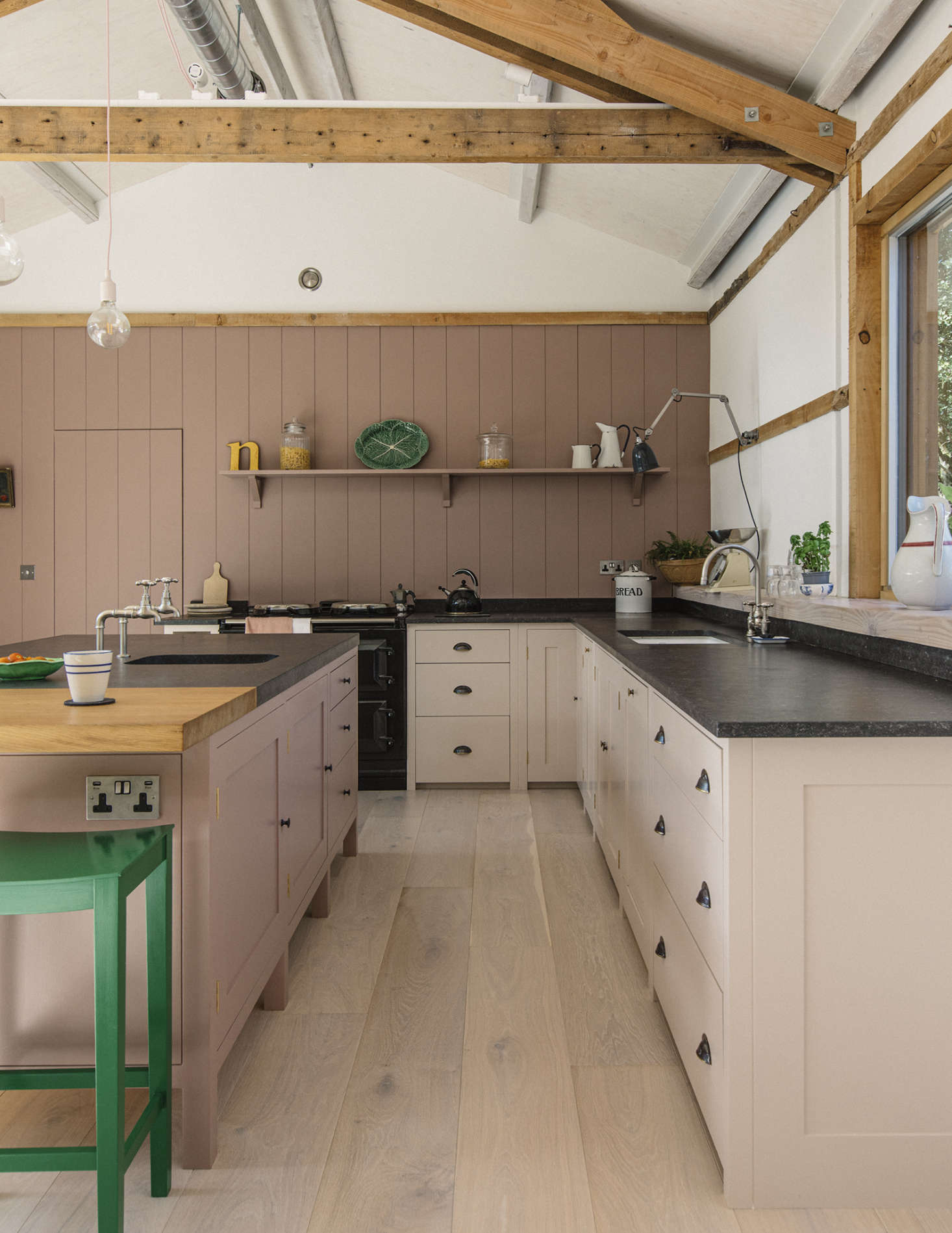 The kitchen cabinets are made of poplar with oak veneered interiors and solid oak dovetailed drawers. The counters are blue-black Belgian fossil stone with an 