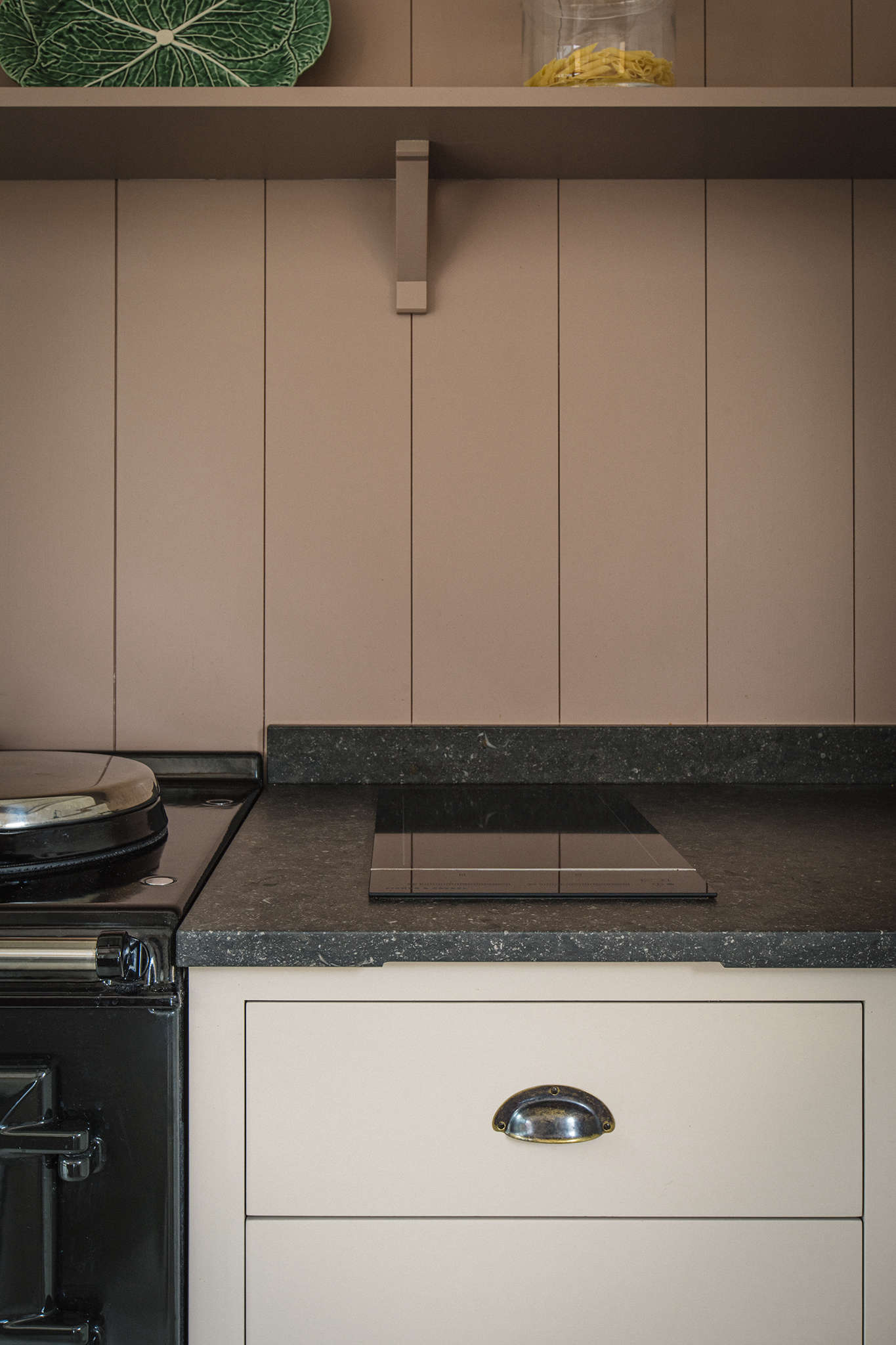 The Fisher & Paykel induction cooktop is big enough for two pans. The Aga has an internal vent for the ovens—the pipe goes to an external wall in the pantry—and there