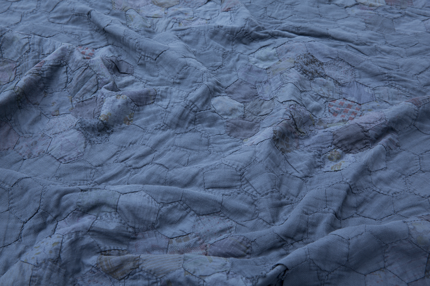From time to time, textile gallery Sharktooth of Williamsburg dyes a stained old quilt indigo to give it a new modern look. Shown here, a Child