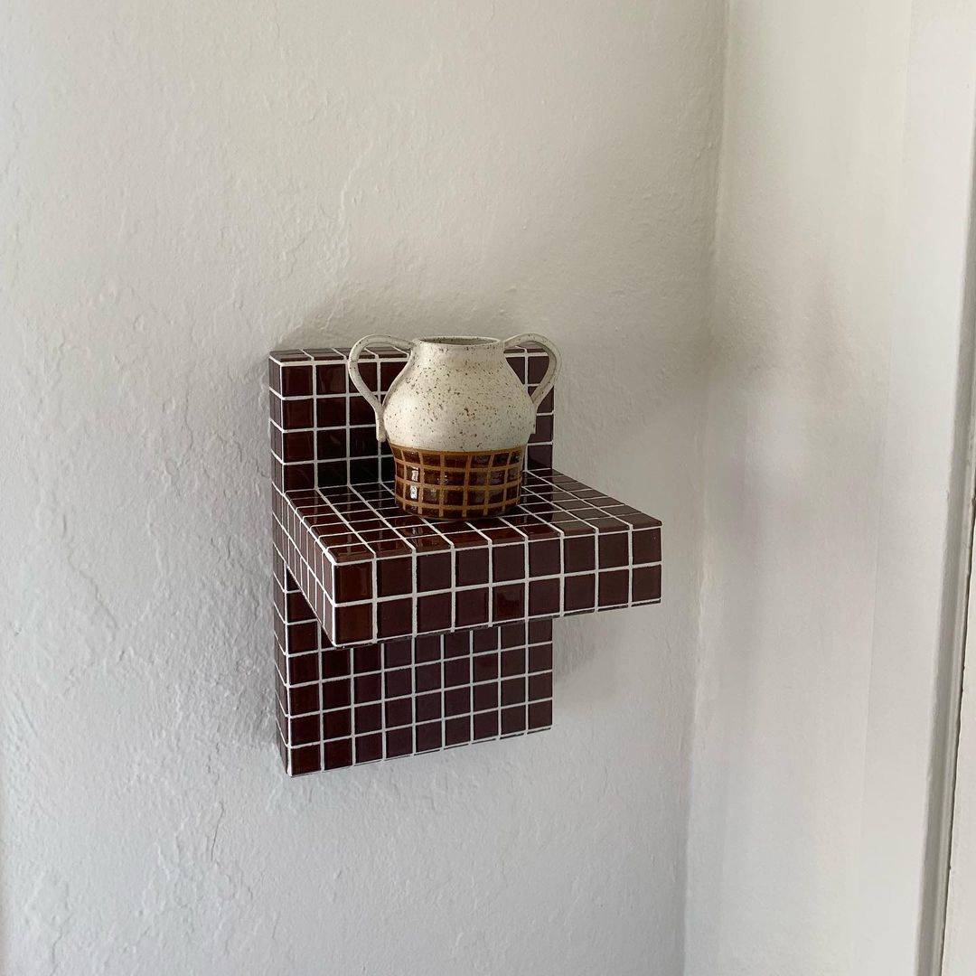 a now sold out floating shelf in a tile color called mushroom; handle vase 26