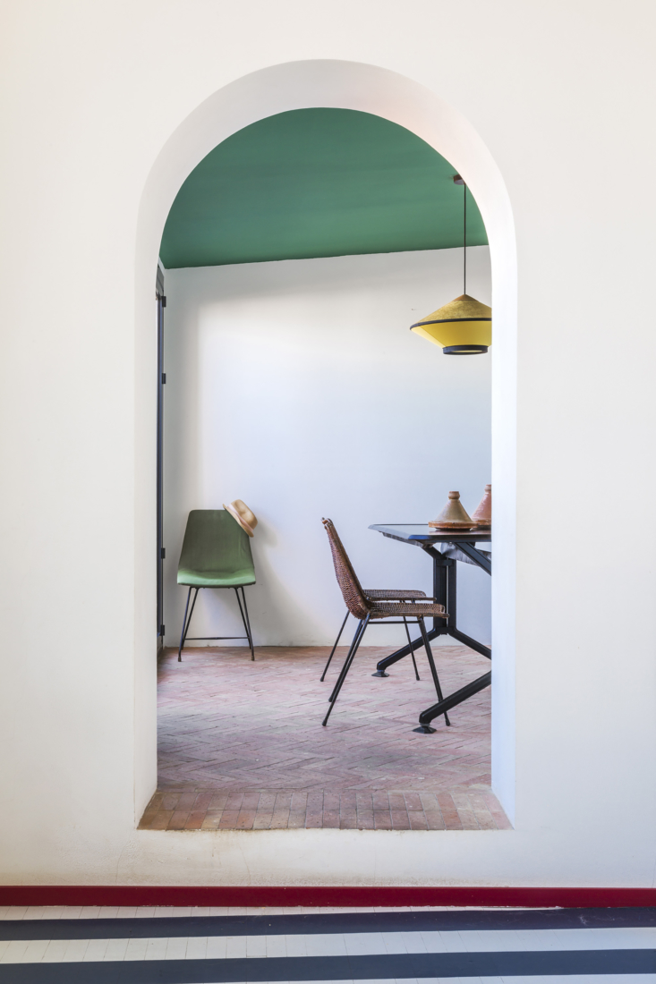 through an archway to the dining area, laid with terra cotta flooring. 19