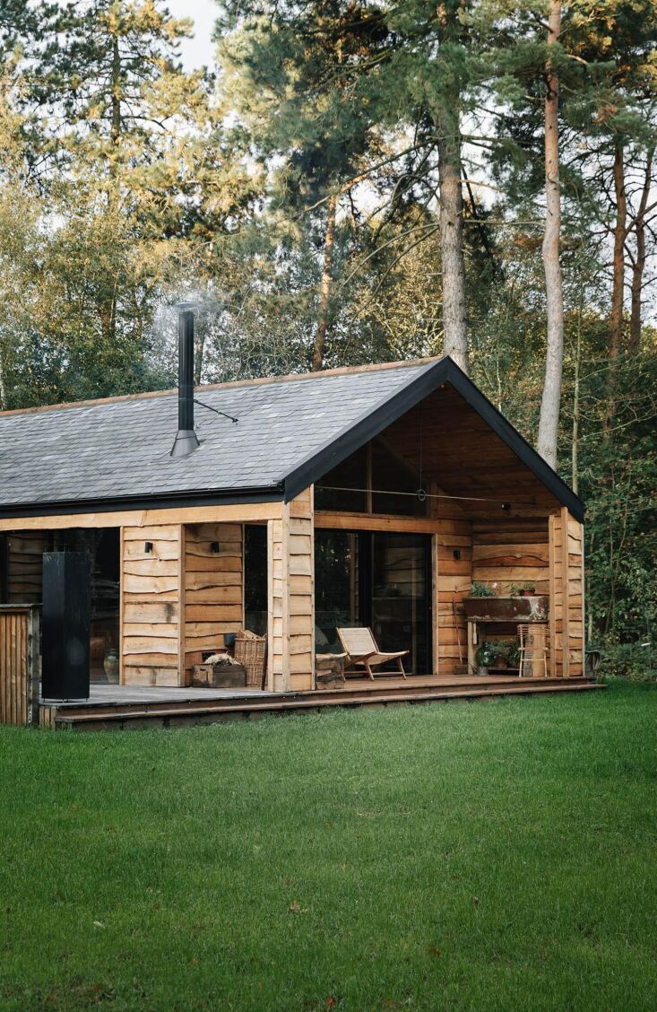 the cabin overlooks a lake with swans. 17