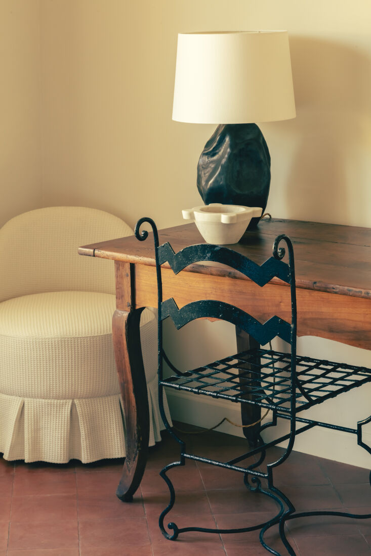 a wrought iron chair and vintage table in a guest room. 29