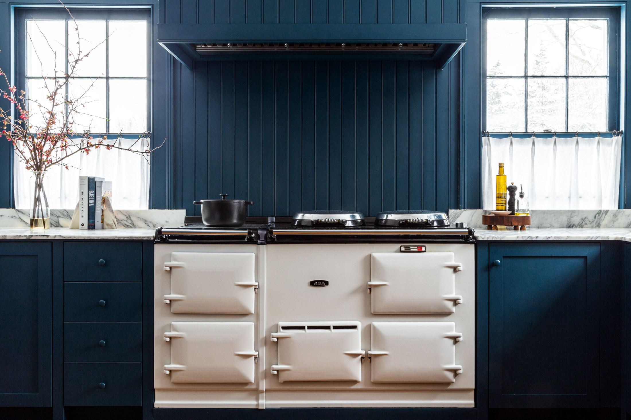 the white aga stove stands out against a sea of blue. photograph by thomas rich 18