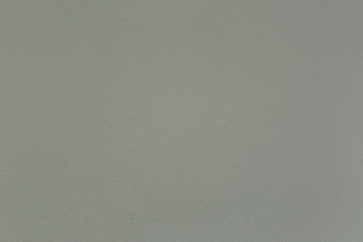 the living room is painted in the atelier ellis smoked green blue. “this is m 19