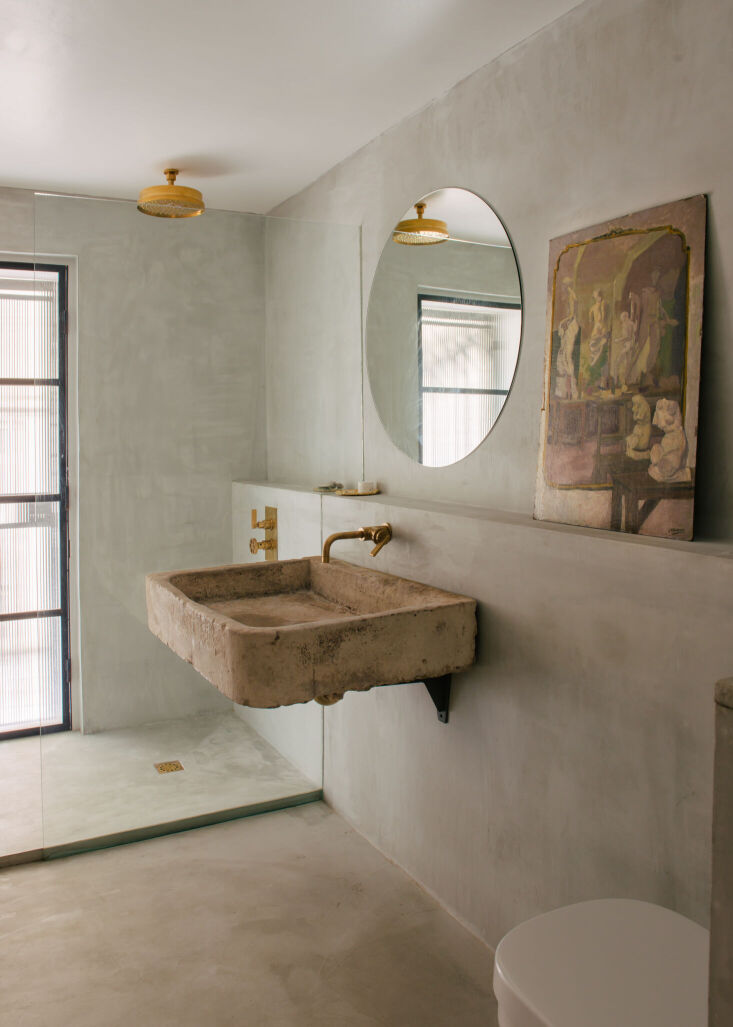rigby designed the shower room with microconcrete, unlacquered brass, and a vin 17