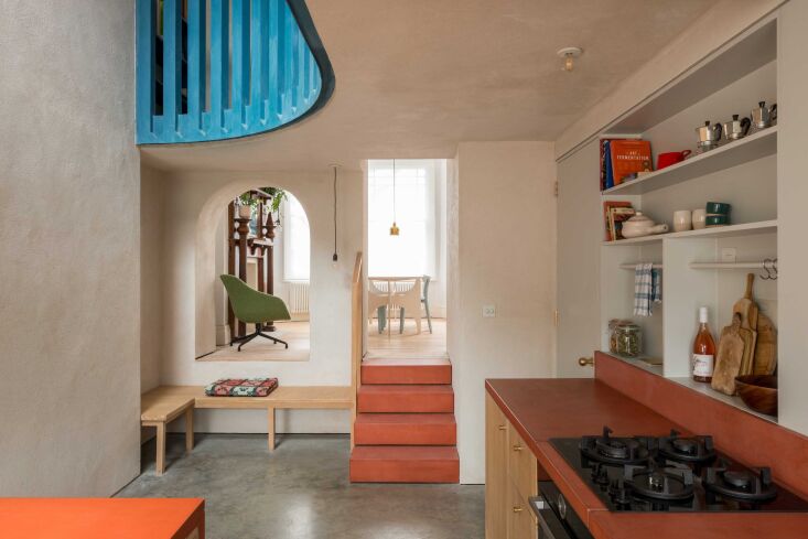 an arched opening and concrete steps link the kitchen to the dining room. 21