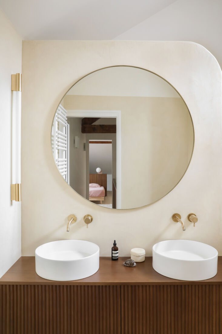 the sink vanity is a companion piece to the headboard. the brass faucets are fr 28