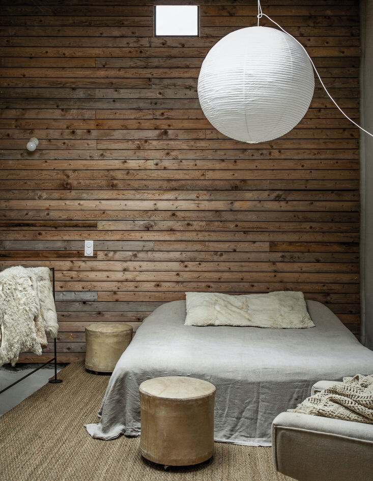 in one of the bedrooms, the moores introduced a paneled wood wall as &#8\2\ 18