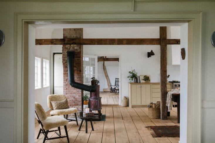 the newly redone kitchen has original beams and a wood stove. the moore house t 18