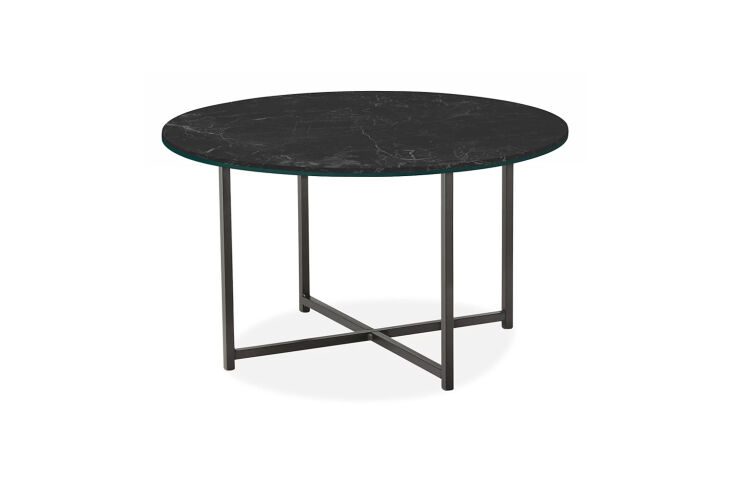 the classic table with marbled black ceramic top is \$749 at room & board. 22