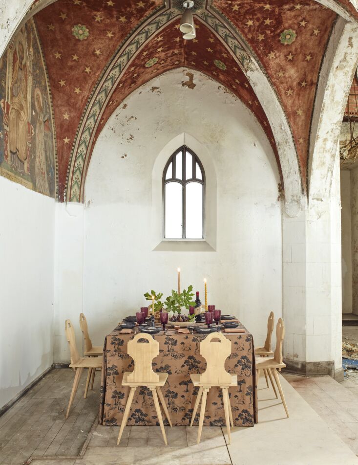 another table, set for dinner and surrounded by swiss dining chairs. 20