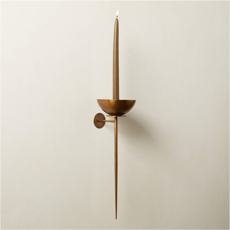 similar in spirit and silhouette is the vela aged brass wall sconce candle hold 18