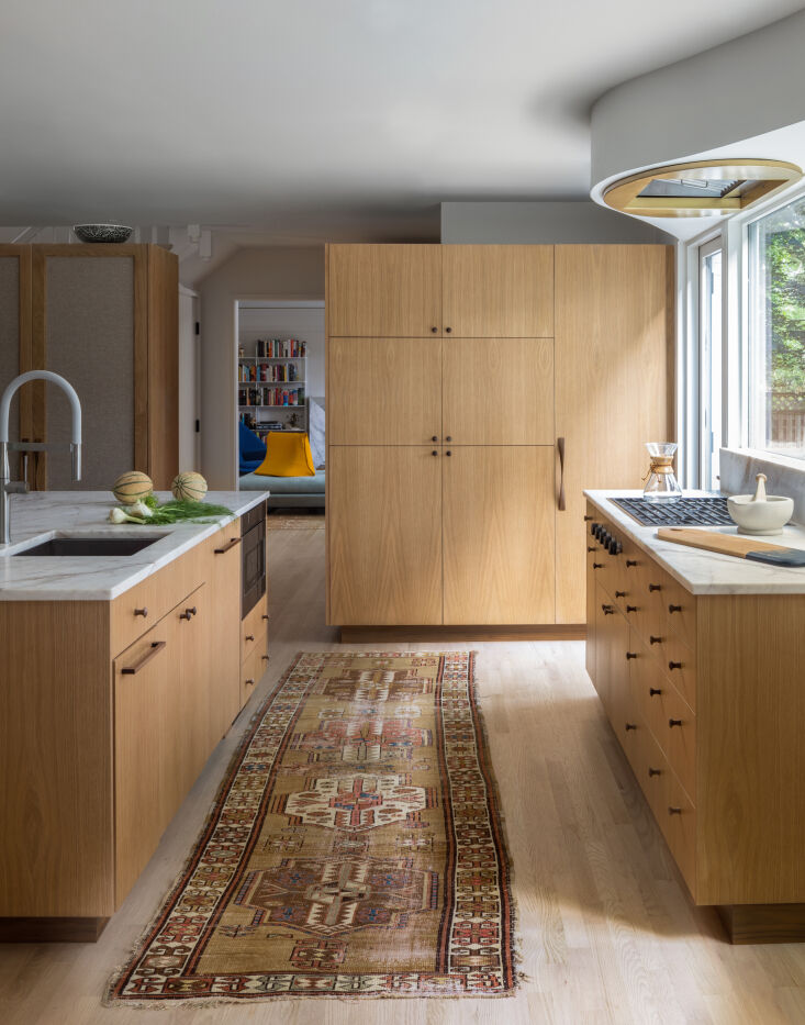 in lieu of the center hall, custom cabinets two feet short of the ceiling serve 21