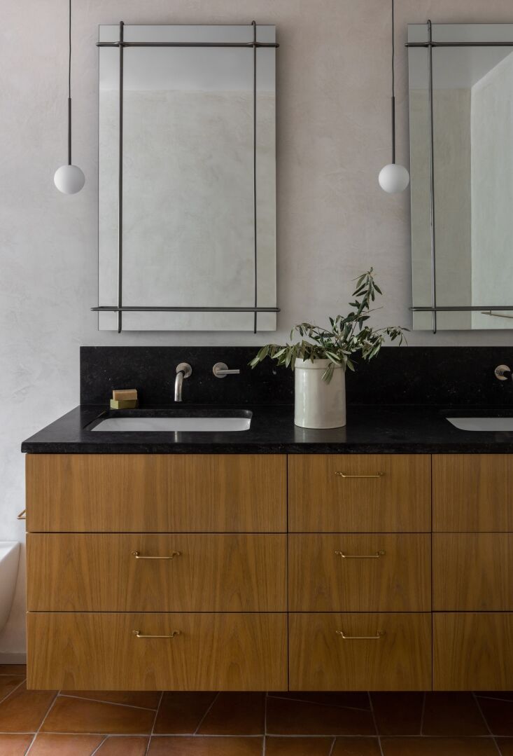 the bath has venetian plaster walls and a white oak vanity topped with honed pe 28