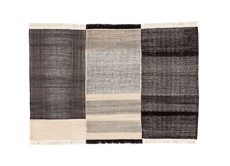 the nanimarquina tres outdoor rug, shown in black, is made of recycled pet to a 23