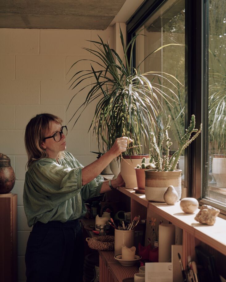 oona tends succulents on the windowsill: \2\20;we have plants inside and 25