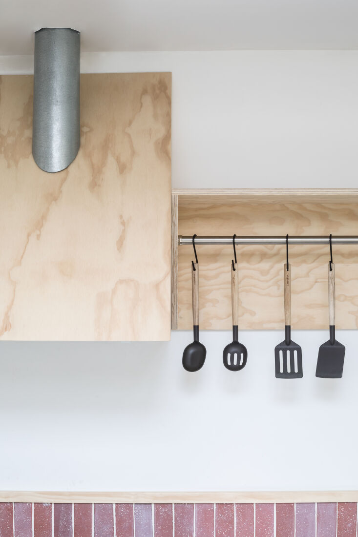 green pan greenlife utensils hang from the rail. 21
