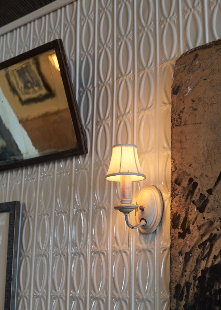 inspired by the existing tin ceiling over the bar, the couple installed tin wal 27