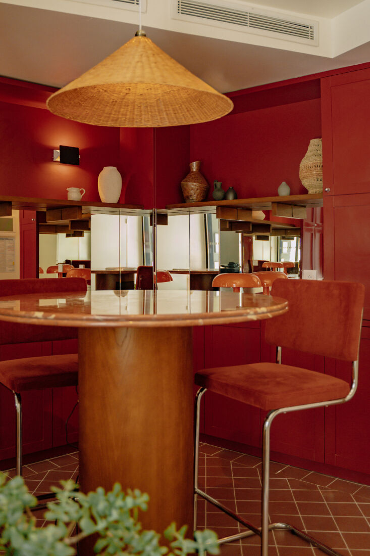 with terracotta tile floors, a rattan pendant, and potted plants, the lobby bri 18