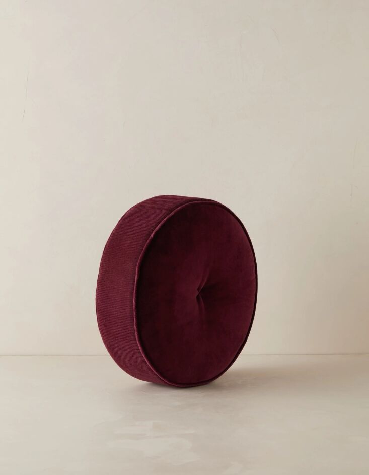 the piped edge velvet disc pillow by sarah sherman samuel, shown here in wine,  22