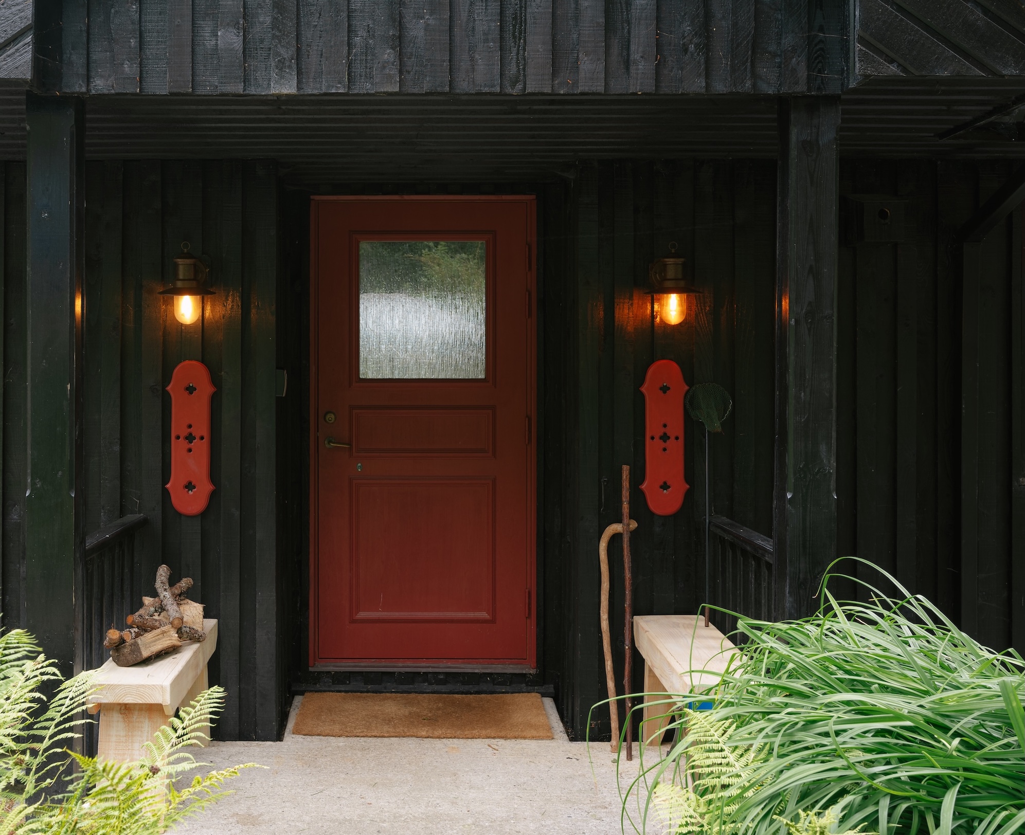 the front doors and window trim are in an iron oxide red synonymous with swedis 18