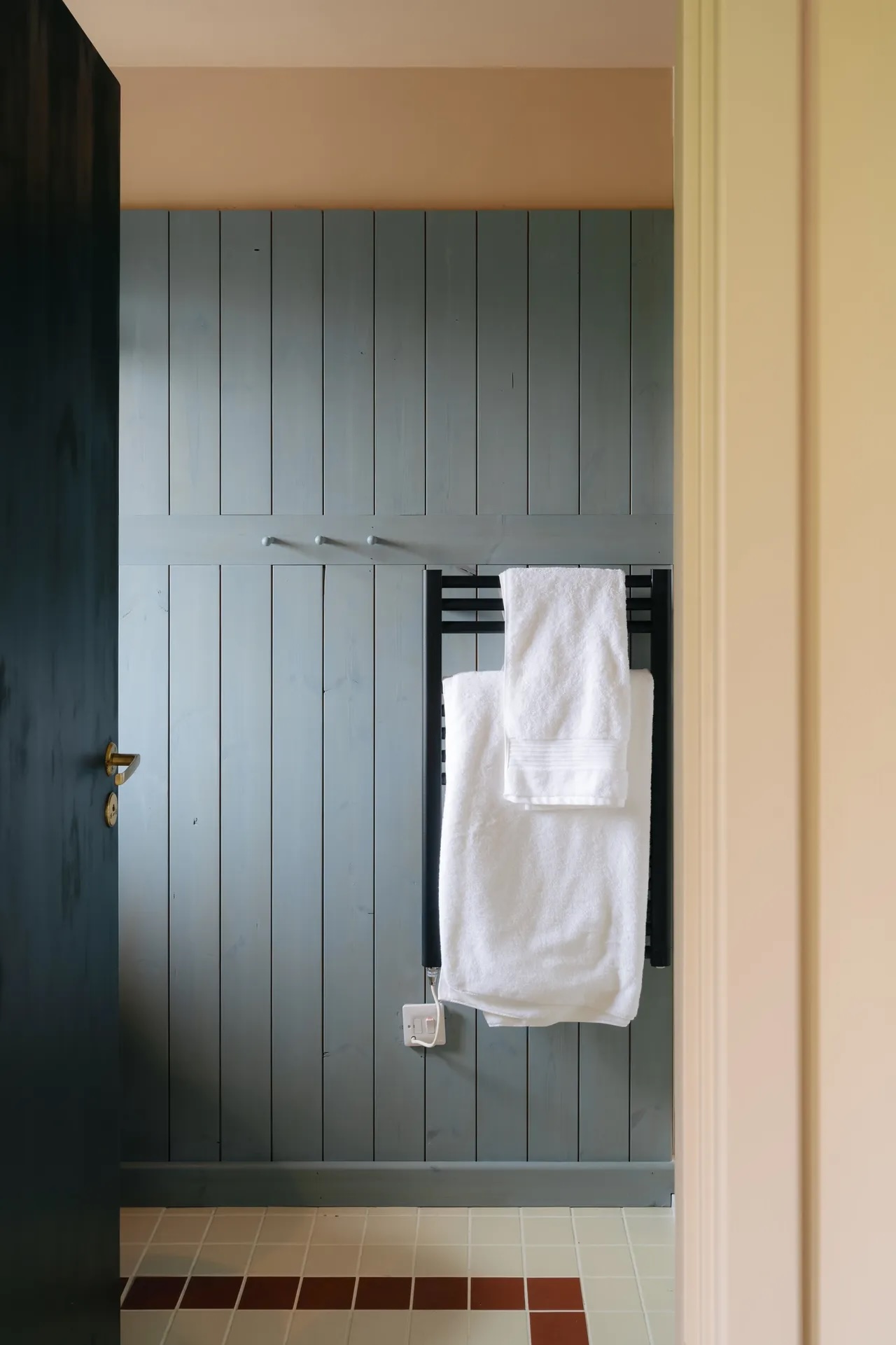 there are two paneled bathrooms with towel warmers. 25