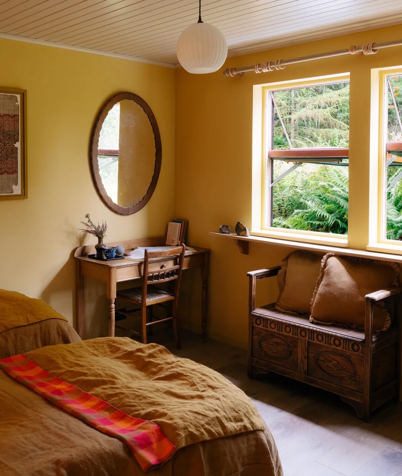 a writing desk and antique settle in one of the house\2\17;s two bedroom 24