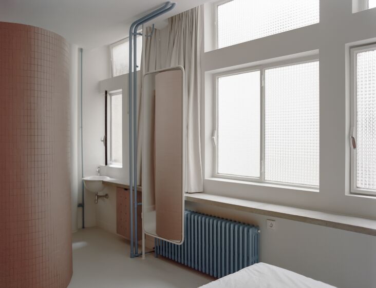 the architects designed a curved shower enclosure, similar to the one seen in l 24