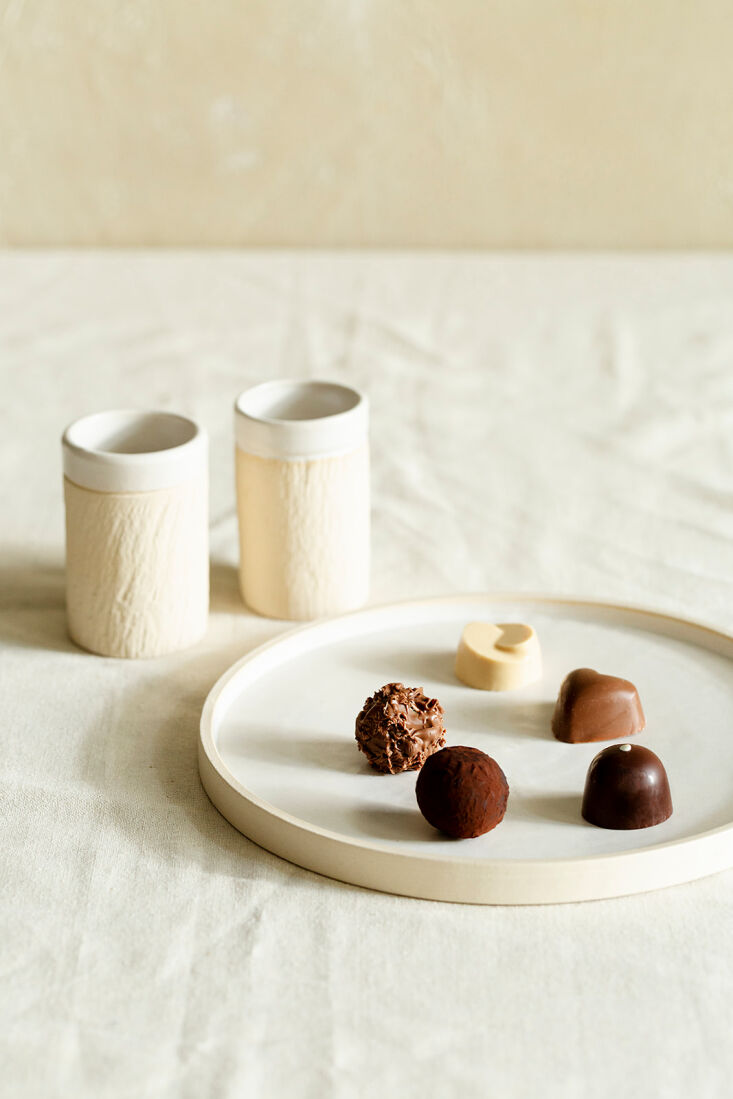 bond espresso cups and a plate of chocolates. 29