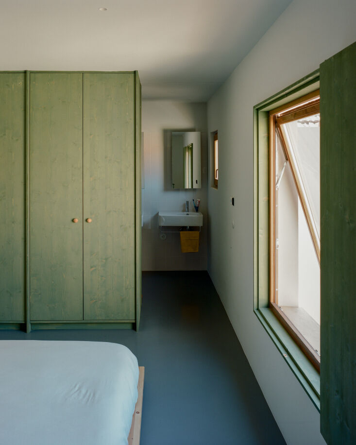 a row of closets separates the bedroom from the ensuite bath. a large awning wi 24