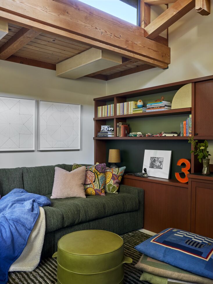 a sitting corner in the bedroom features floor pillows and a leather finished o 30