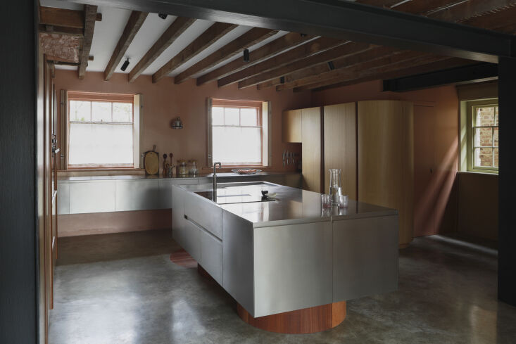 the custom cabinets are rounded on one side of the partial u shaped kitchen. &a 20