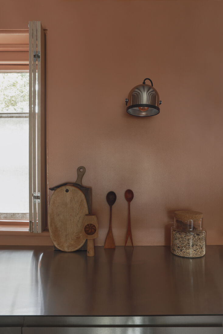 the wall sconce is an antique find by gae aulenti. the shutters are made custom 22