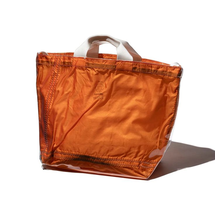 the covered parachute shoulder bag is available in orange o4 white; \$80, from  21