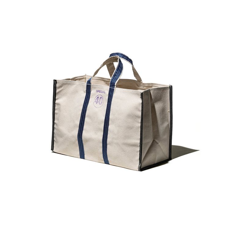 stitched from recycled tent and awning canvas, the market tote bag is modeled  26