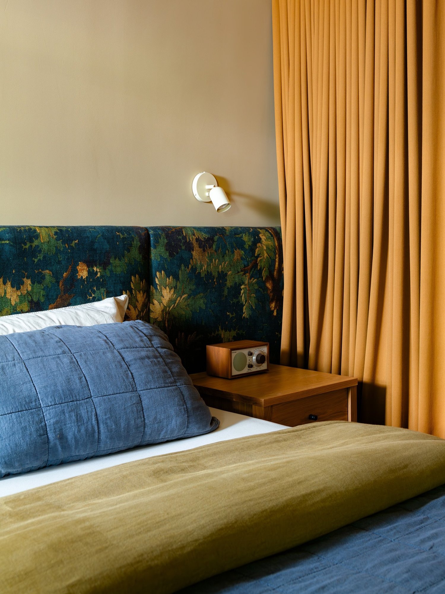 the custom headboard is upholstered in schwarzwald 003, an italian linen from d 23