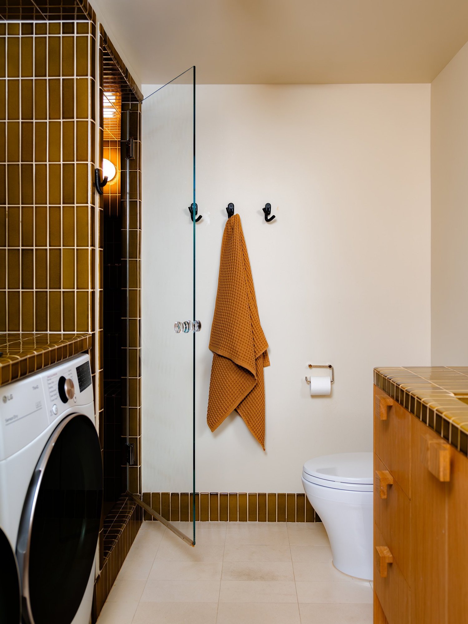 the architects gracefully integrated a washing machine and dryer. the leggy cro 26