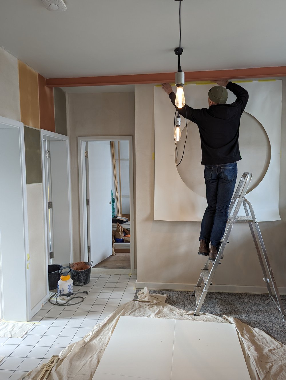 john frankland hangs a circle template that he dampened slightly to adhere to t 28