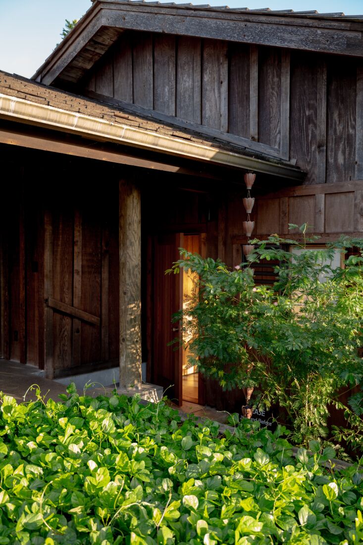 the house is built with natural building materials, such as lava rock and redwo 17