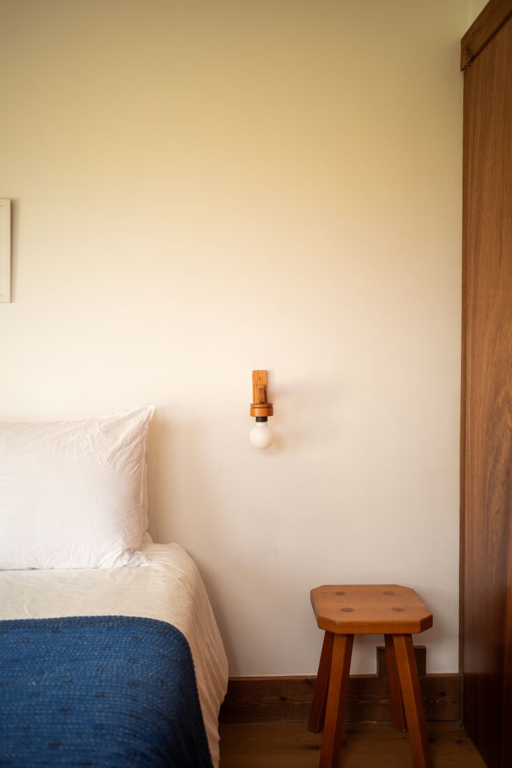the guest bedroom features a pine wood sconce designed by beatrice and a french 32
